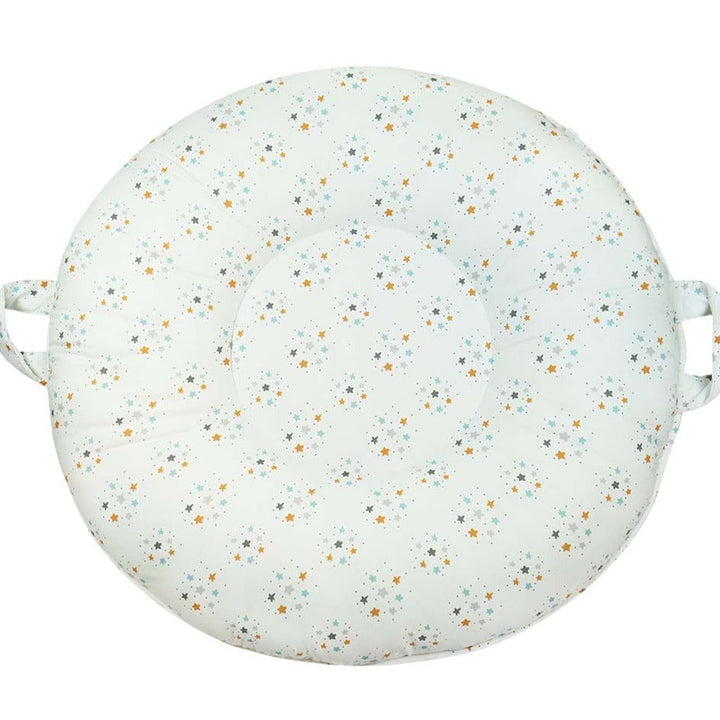 White round floor cushion with small stars in gray, light blue, and yellow.  