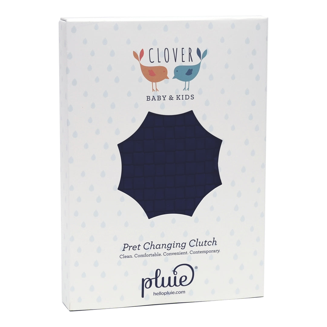 Box packaging for a 'Pret Changing Clutch' by pluie with 'Clover Baby & Kids' branding.