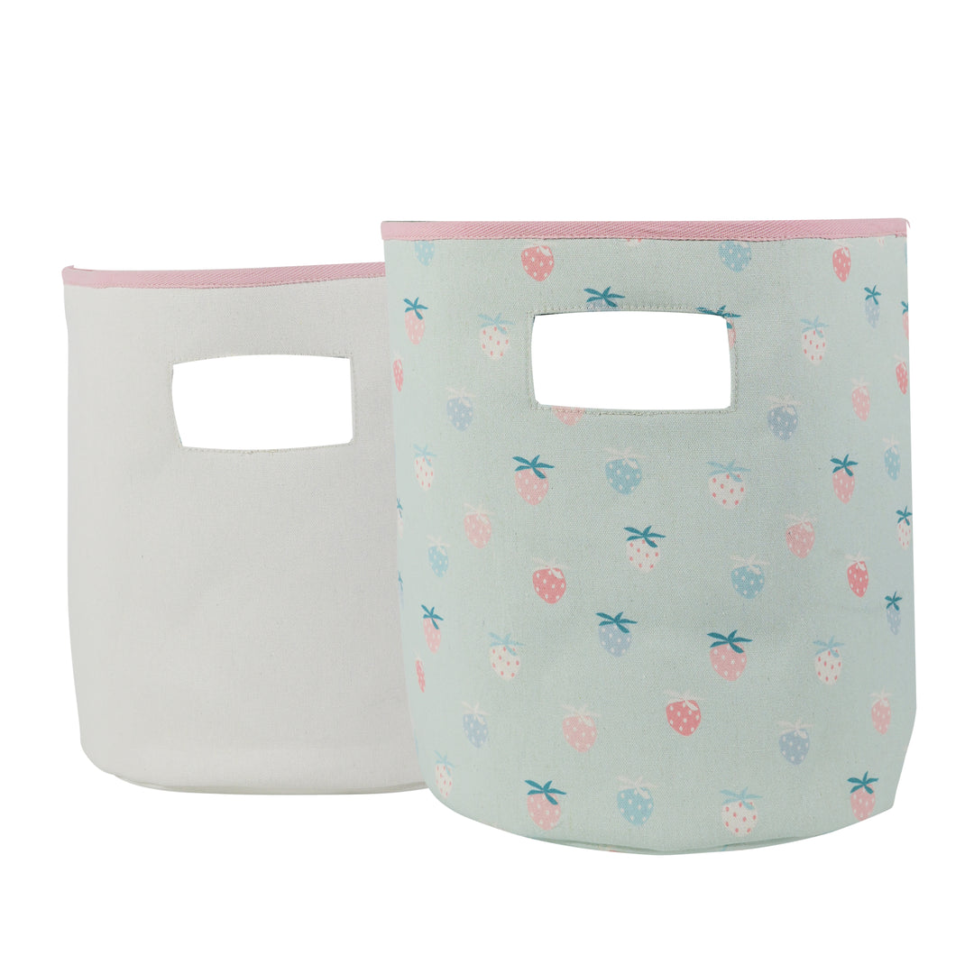 Two soft storage bins, one solid white and one with a multicolored pattern featuring animals such as dinosaurs.