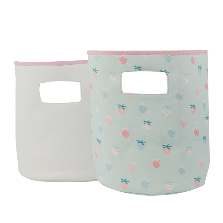 Two soft storage bins, one solid white and one with a multicolored pattern featuring animals such as dinosaurs.