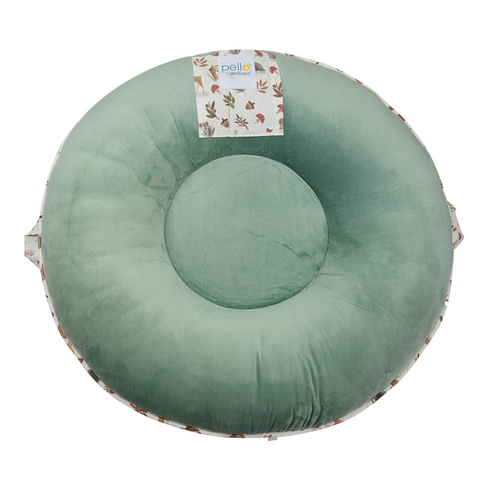 Back view of Pello's Cedar Floor Cushion showing a solid green back, peek a boo pocket and handle.