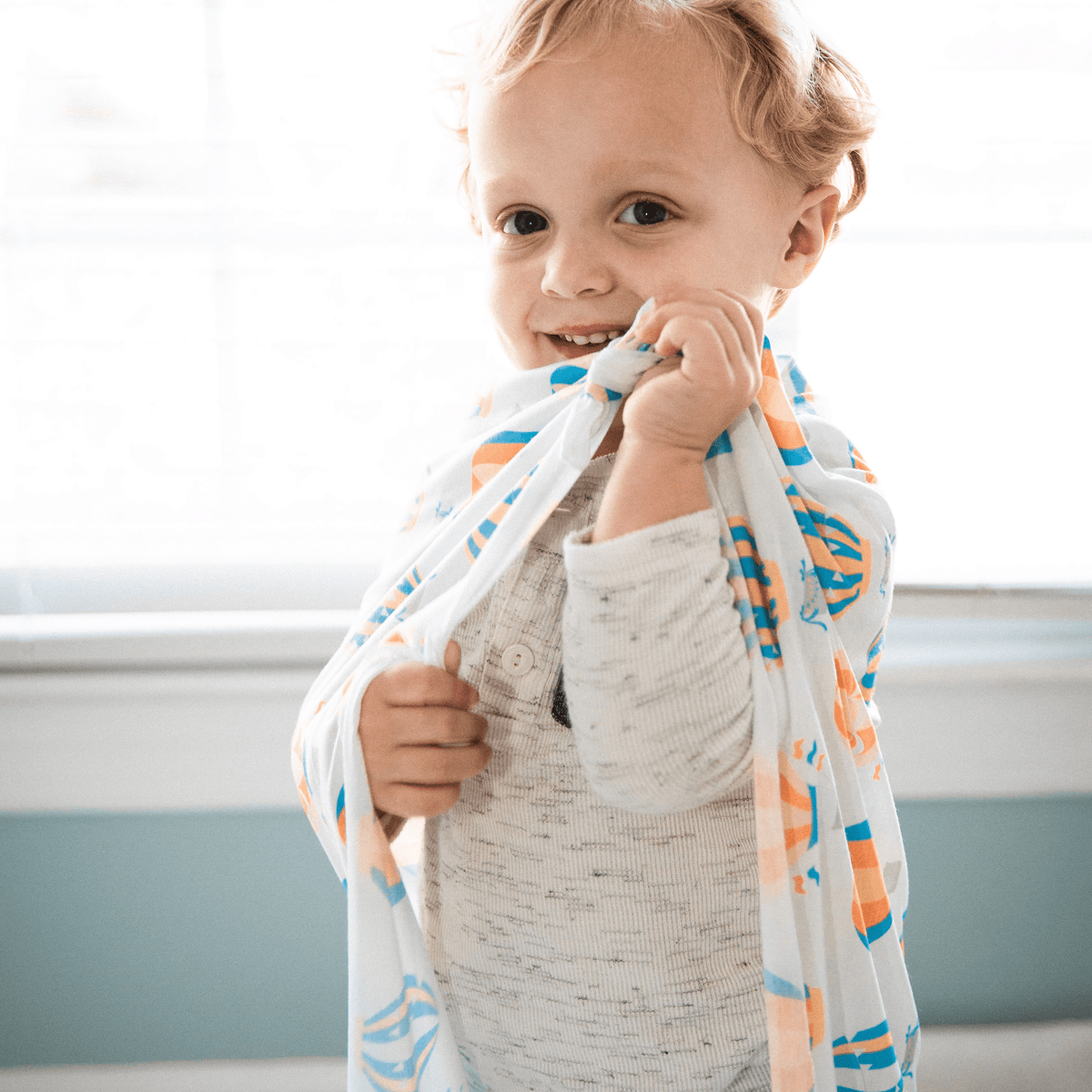 Toddler Girl Playing With Receiving Blanket